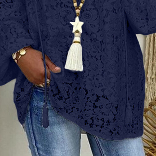 Woman wearing blue lace blouse and denim.