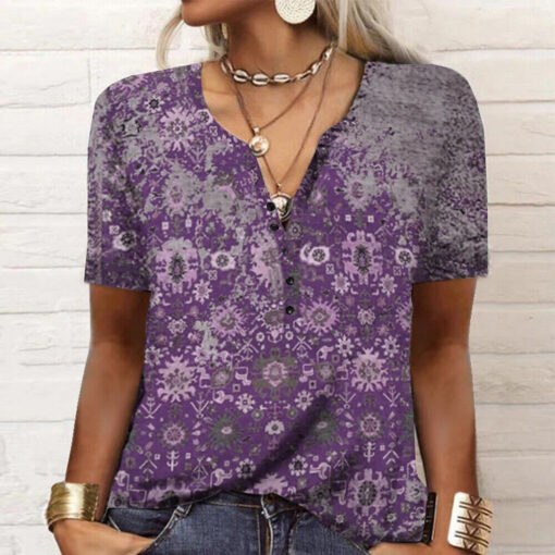 Woman wearing purple patterned blouse with accessories.