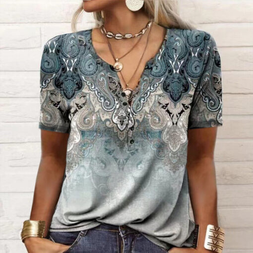 Woman wearing ornate paisley patterned top with accessories.