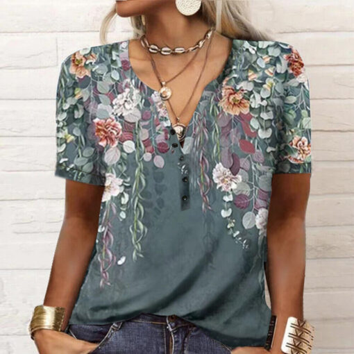 Woman wearing floral V-neck blouse with accessories.