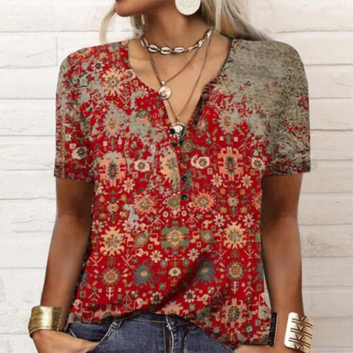 Woman wearing red bohemian patterned blouse with accessories.