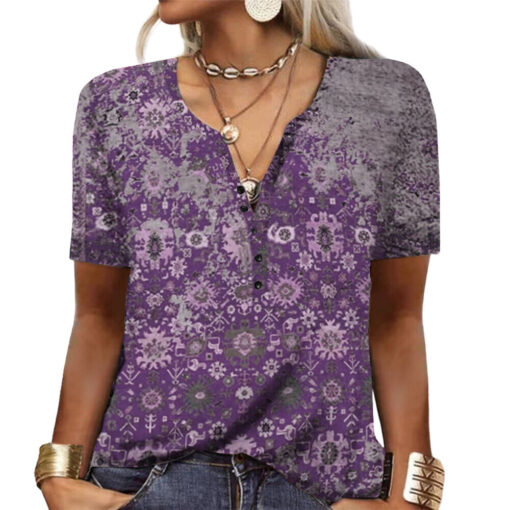 Woman wearing purple patterned blouse with accessories.