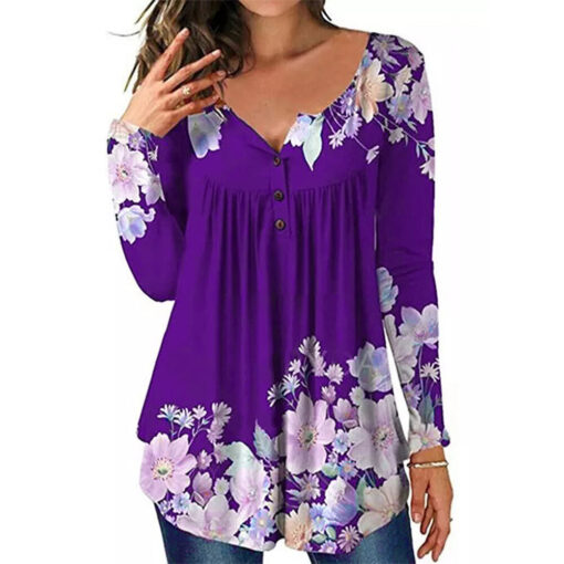 Woman wearing purple floral blouse with V-neckline.