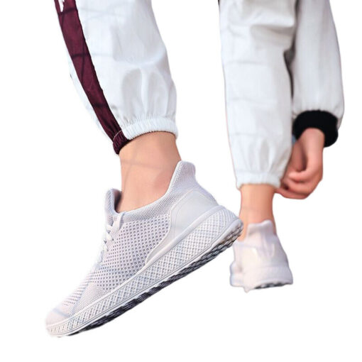 Person wearing white sneakers and jogger pants.