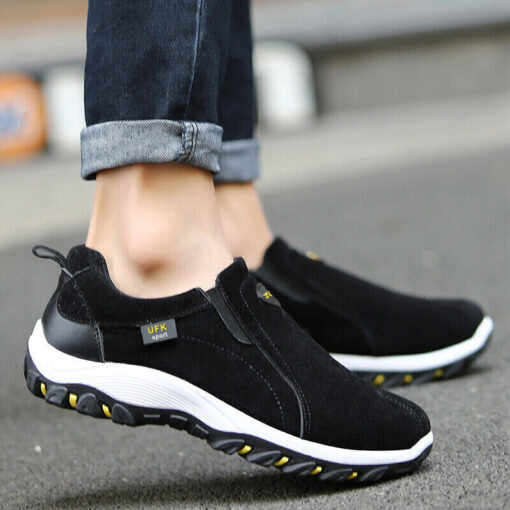 Black slip-on sneakers on pavement