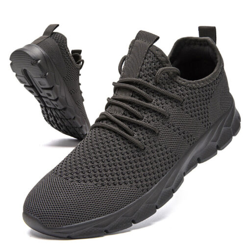 Black athletic running shoes on white background.