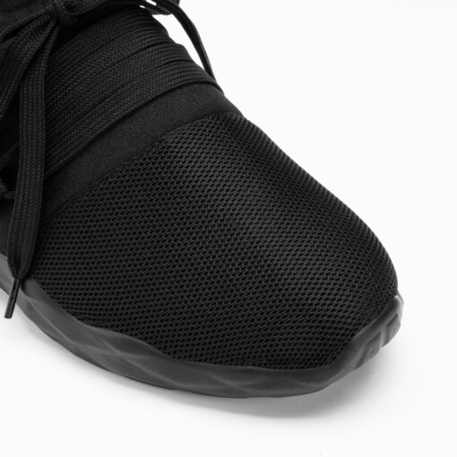 Black athletic sneaker close-up on white background.