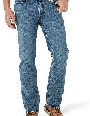 Man modeling classic blue jeans with brown shoes.