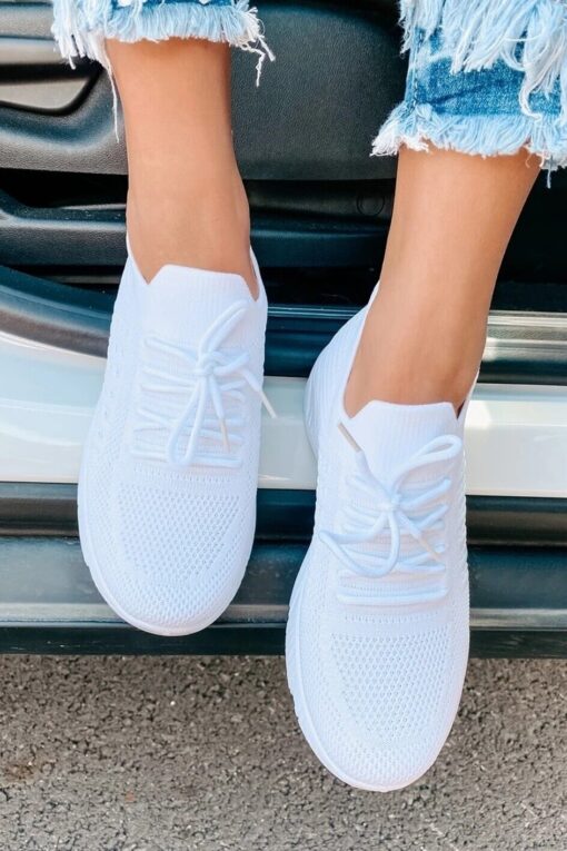 White sneakers and frayed denim shorts.