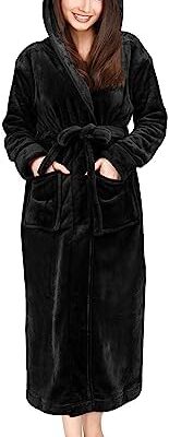 Woman wearing black hooded bathrobe with pockets.