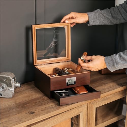Person organizing items in wooden lockbox with mirror.