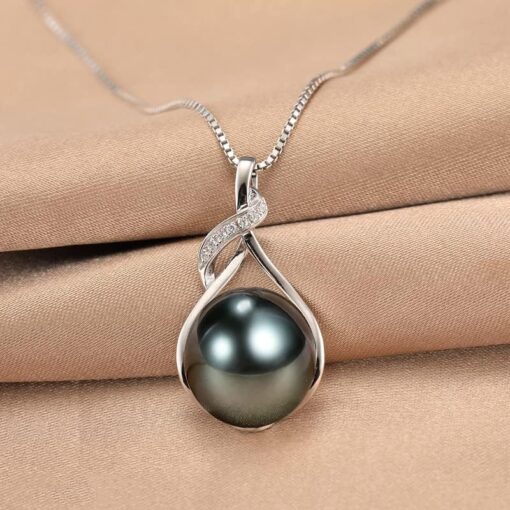 Elegant silver pearl necklace on satin background.