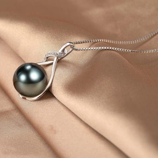 Elegant black pearl necklace on silk fabric