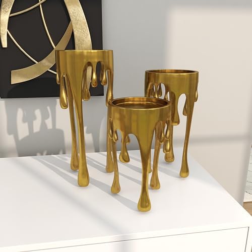 Gold melting-style cup planters on a table.